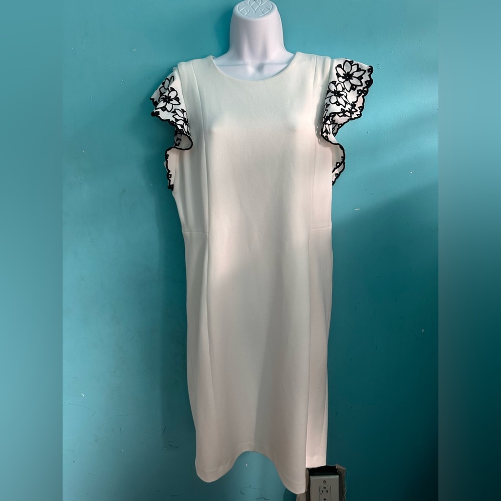 White dress with black floral shoulder/arm area. Worn once. Has spandex